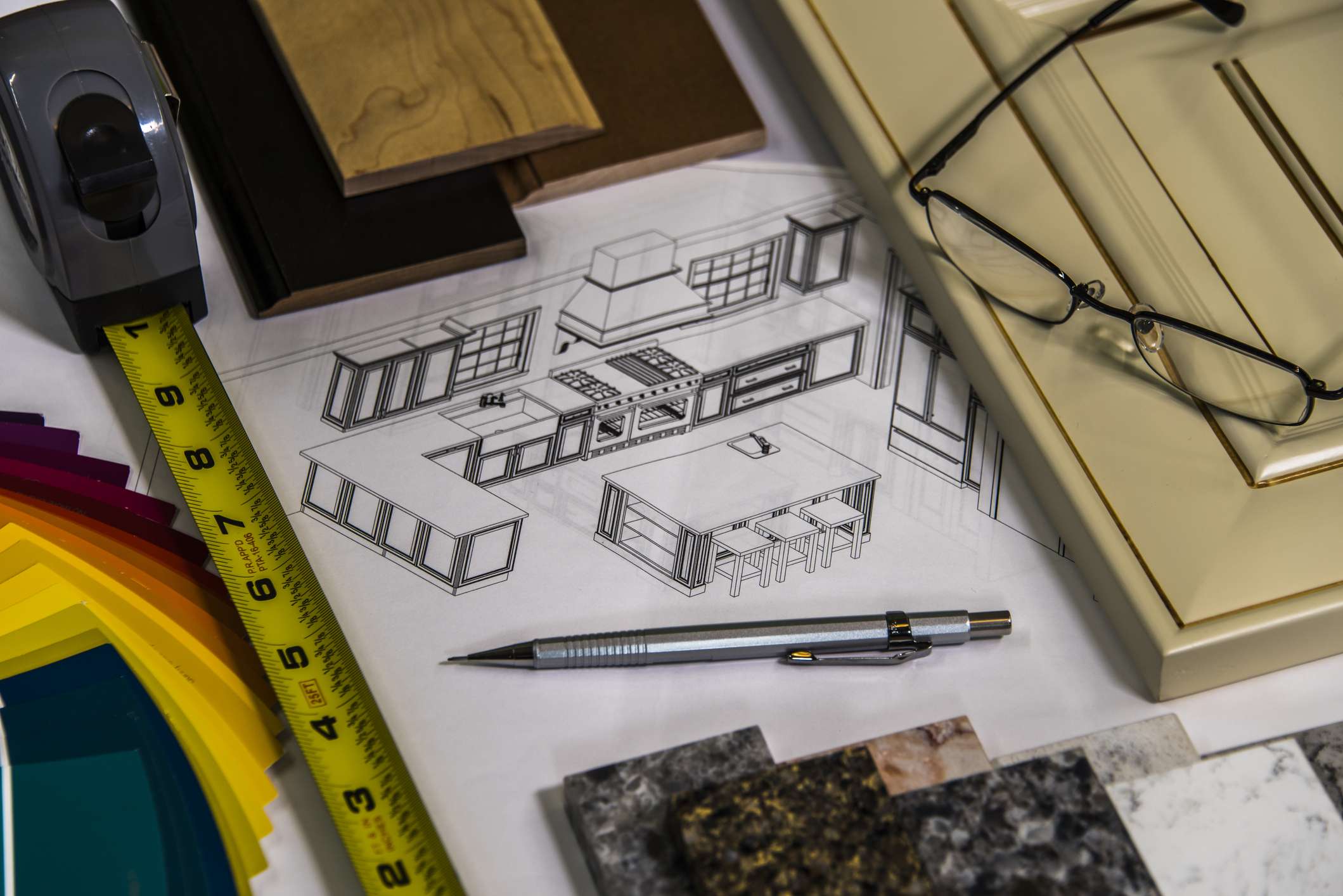 Kitchen remodel planning sketch with cabinet samples, countertop materials, tape measure, and color swatches for a Boise permit-required renovation